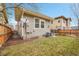 Exterior view of the home's side and backyard featuring green grass and a wooden fence at 10452 Rutledge St, Parker, CO 80134