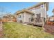 A fenced backyard with green grass and a deck, creating a welcoming outdoor space at 10452 Rutledge St, Parker, CO 80134