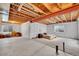Unfinished basement featuring a bed and exposed ceiling, offering potential for customization at 10452 Rutledge St, Parker, CO 80134