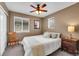 Cozy bedroom with a ceiling fan, two windows, and a nightstand for convenience at 10452 Rutledge St, Parker, CO 80134