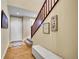 Welcoming entryway featuring hardwood floors, staircase, and a cozy bench for comfortable seating at 10452 Rutledge St, Parker, CO 80134