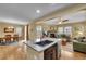 Modern kitchen with island seating area that opens into dining and living rooms at 10452 Rutledge St, Parker, CO 80134