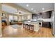 Open concept kitchen and living room featuring stainless steel appliances, center island, and hardwood floors at 10452 Rutledge St, Parker, CO 80134