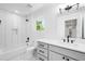 Modern bathroom featuring a subway tile shower, hexagon tile floor, and white vanity at 4640 W 39Th Ave, Denver, CO 80212