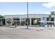 Wide view of building with a cluster of businesses with white parasols for outside seating at 4640 W 39Th Ave, Denver, CO 80212