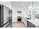Modern kitchen with stainless steel appliances, white countertops, and sleek finishes at 4640 W 39Th Ave, Denver, CO 80212