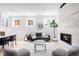 Cozy living room with a modern fireplace, large windows, and a comfortable sofa at 4640 W 39Th Ave, Denver, CO 80212