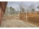 Wooden back deck features lattice privacy screen and railings for outdoor enjoyment at 26167 De Berry St, Conifer, CO 80433