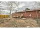 Backyard featuring a raised wooden deck with steps in a wooded area at 26167 De Berry St, Conifer, CO 80433