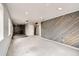 Basement offers stone fireplace and accent wall with gray wooden panels at 26167 De Berry St, Conifer, CO 80433