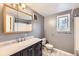 Bathroom featuring black vanity, a shower/tub combination, and a vanity mirror at 26167 De Berry St, Conifer, CO 80433