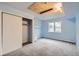 Bedroom featuring blue walls, neutral carpet, closet and a window with outdoor views at 26167 De Berry St, Conifer, CO 80433