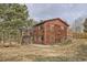 This home offers a rustic exterior with a wooden deck and surrounding natural landscape, perfect for nature lovers at 26167 De Berry St, Conifer, CO 80433