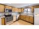 Traditional kitchen showcasing wood cabinets, stainless steel appliances, and durable countertops at 26167 De Berry St, Conifer, CO 80433
