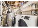Laundry room featuring modern Samsung washer and dryer and a water heater at 26167 De Berry St, Conifer, CO 80433