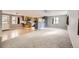 A bright living room and kitchen offers an open floor plan and natural light, with a blend of flooring types at 26167 De Berry St, Conifer, CO 80433