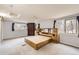 Spacious main bedroom with a wooden bed frame, natural light, and neutral walls at 26167 De Berry St, Conifer, CO 80433