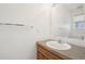 Bathroom with a single sink, mirror, and bright lighting at 711 Elm St, Frederick, CO 80530