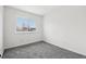 Bedroom featuring a large window that provides natural lighting and new carpet at 711 Elm St, Frederick, CO 80530