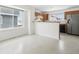 Eat-in kitchen area with modern stainless steel appliances, wood cabinets, and a large window for natural light at 711 Elm St, Frederick, CO 80530