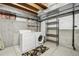 Unfinished basement laundry area with white washer and dryer at 711 Elm St, Frederick, CO 80530