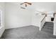 Bright living room with neutral carpet, white walls, and stairs leading up to the next level of the home at 711 Elm St, Frederick, CO 80530