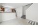 Open concept living area leading to the kitchen, featuring stairs and neutral flooring for a modern feel at 711 Elm St, Frederick, CO 80530