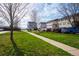 Apartments with green space, picnic tables, and parking under a partly cloudy blue sky at 711 Elm St, Frederick, CO 80530