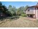 Spacious backyard featuring a large lawn, mature trees, and privacy fencing at 8952 W Stanford Ave, Denver, CO 80123