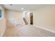 Finished basement with neutral carpet and trim and door leading to the stairs at 8952 W Stanford Ave, Denver, CO 80123