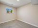 Finished basement with neutral carpet and a bright window at 8952 W Stanford Ave, Denver, CO 80123