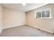 Bedroom features neutral carpet and trim, bright window to the outside at 8952 W Stanford Ave, Denver, CO 80123