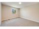 Bedroom features neutral carpet and trim, a bright window, and ample space at 8952 W Stanford Ave, Denver, CO 80123