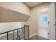 Hallway with decorative railing, carpeted stairs and open bathroom at 8952 W Stanford Ave, Denver, CO 80123