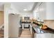 Modern kitchen featuring stainless steel appliances, sleek countertops, and ample white cabinetry at 8952 W Stanford Ave, Denver, CO 80123