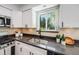 Modern kitchen featuring stainless steel appliances, sleek countertops, and ample white cabinetry at 8952 W Stanford Ave, Denver, CO 80123