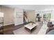 Inviting living area featuring hardwood floors, a modern staircase, and an open layout that flows into the dining area at 8952 W Stanford Ave, Denver, CO 80123