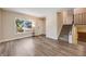 Bright living room with hardwood floors, a large window, and stairs leading to the upper level at 8952 W Stanford Ave, Denver, CO 80123