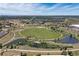 Expansive aerial shot of a park with a large green field, pond, and walking trails at 507 Ulster Way, Denver, CO 80230