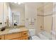 Bathroom featuring a granite countertop vanity, shower with tile surround and view to bedroom at 507 Ulster Way, Denver, CO 80230