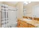 Well-lit bathroom features a vanity with granite countertop, a shower-tub combo, and modern fixtures at 507 Ulster Way, Denver, CO 80230