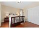 Comfortable bedroom with hardwood floors, a large bed, and a sliding door closet at 507 Ulster Way, Denver, CO 80230