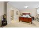 Bedroom featuring a wooden bed frame, carpeted floor, and ensuite bathroom, offering comfort and convenience at 507 Ulster Way, Denver, CO 80230