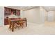 Dining area with wooden table and chairs, adjacent to a bar with wooden cabinetry and plenty of light at 507 Ulster Way, Denver, CO 80230