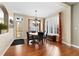 Bright dining room featuring a chandelier, hardwood floors, and a large window with plantation shutters at 507 Ulster Way, Denver, CO 80230