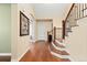 Open foyer featuring hardwood floors, a staircase with iron balusters, and neutral wall color at 507 Ulster Way, Denver, CO 80230