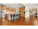 Well-lit kitchen featuring stainless steel appliances, a center island, and wood floors at 507 Ulster Way, Denver, CO 80230