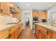 Functional kitchen with stainless steel appliances, wooden cabinets, and easy access to the dining room at 507 Ulster Way, Denver, CO 80230