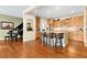 Open concept kitchen with wood floors, a large island, and seamless transition to the living spaces at 507 Ulster Way, Denver, CO 80230