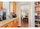 Kitchen pantry and adjacent dining room with natural light and hardwood floors at 507 Ulster Way, Denver, CO 80230